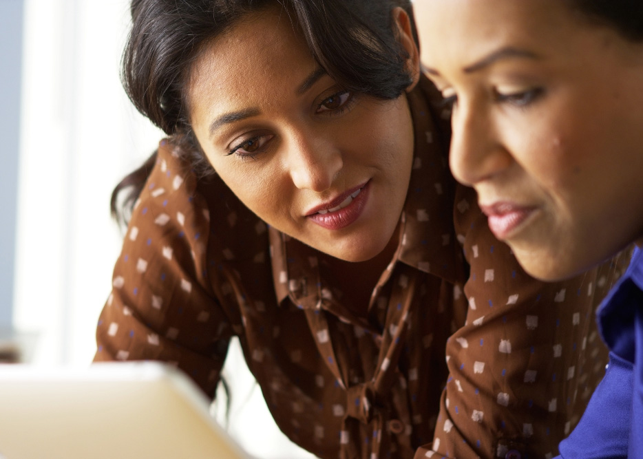 Two women working together