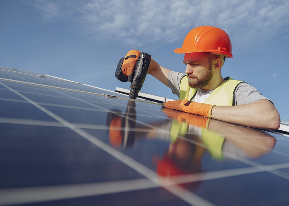 Construction worker fixing solar panels