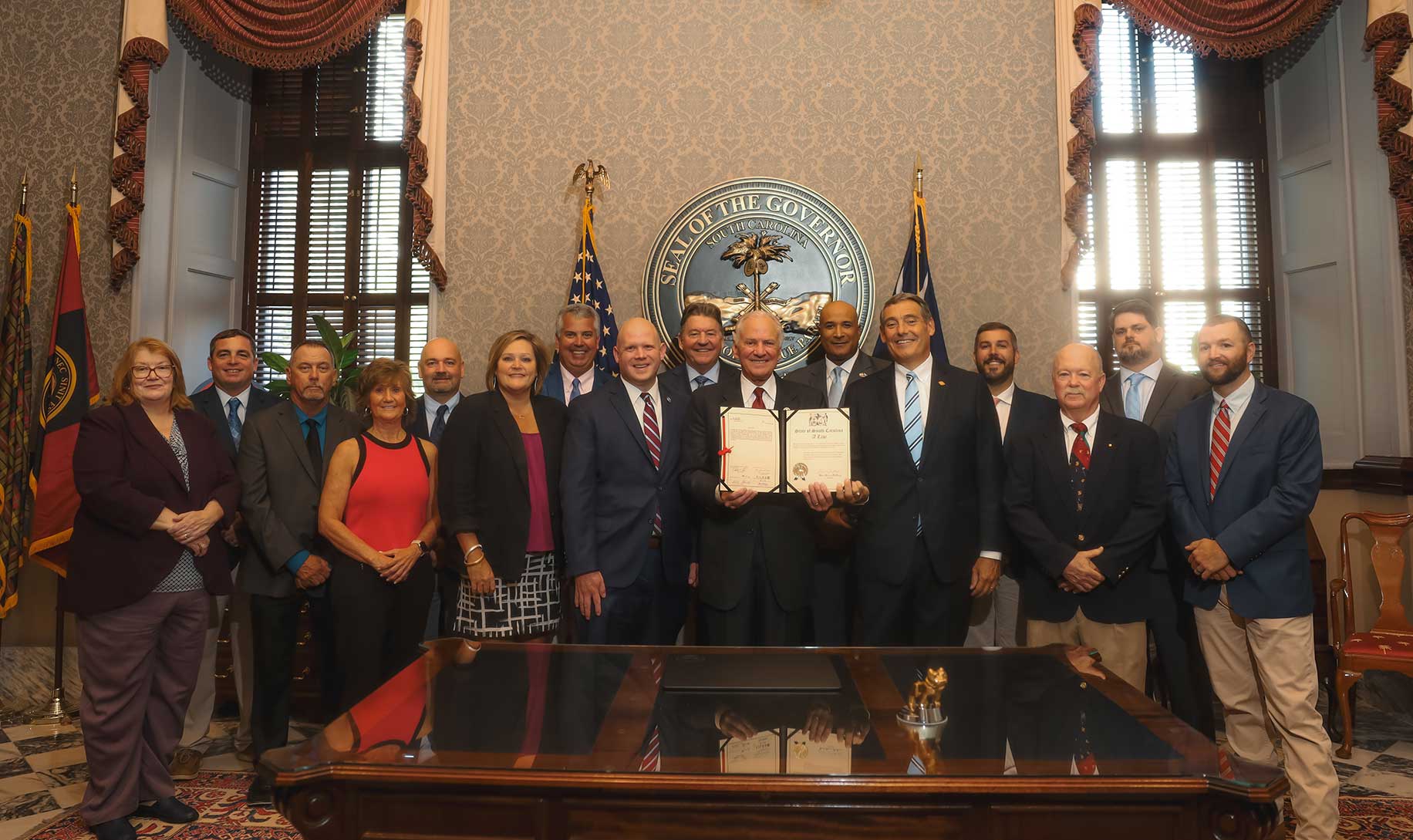 Governor McMaster stands will CAGC staff, members and officials with the singed bill