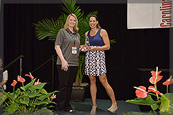 Michelle Reed accepts her Top Young Leader Award from Jessica Mendoza